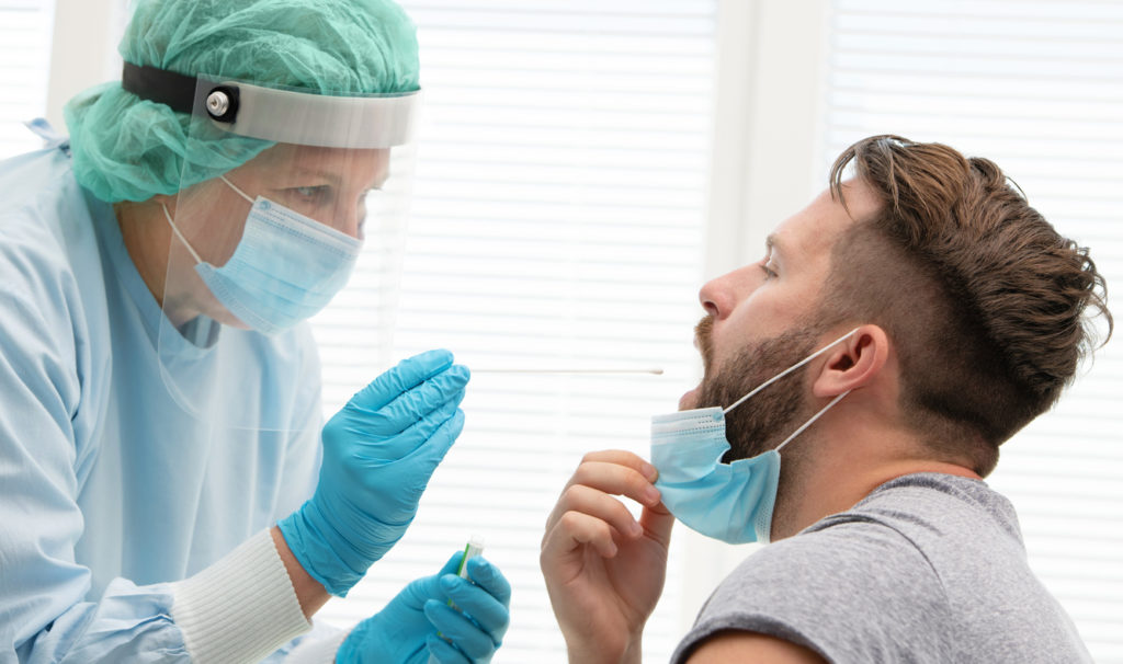 LGBTQ man taking a COVID-19 nasal test.