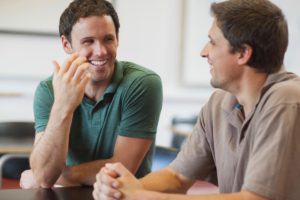 two people sit and discuss a residential treatment program