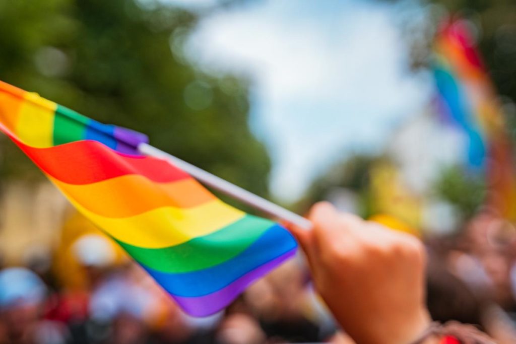 close up of rainbow flag signifying 6 ways to safely celebrate pride month in june 2022