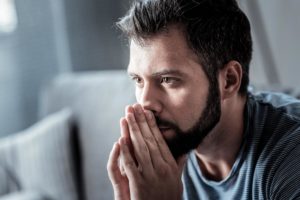 concerned man with head in his hands wondering can you quit meth cold turkey