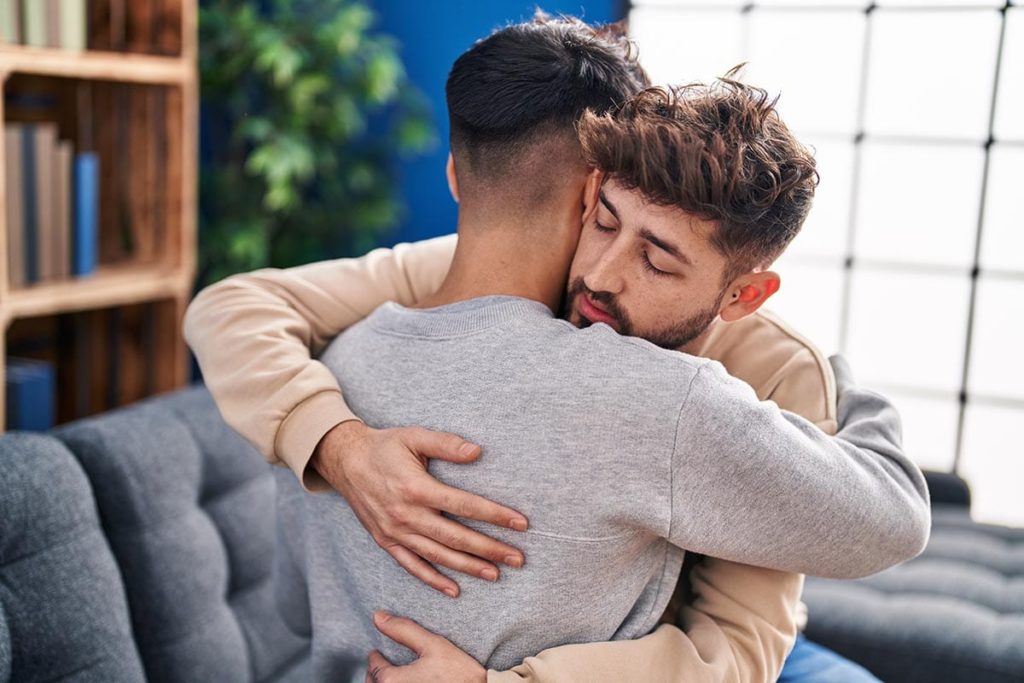 two men embracing as they celebrate debunking the most common myths about meth addiction