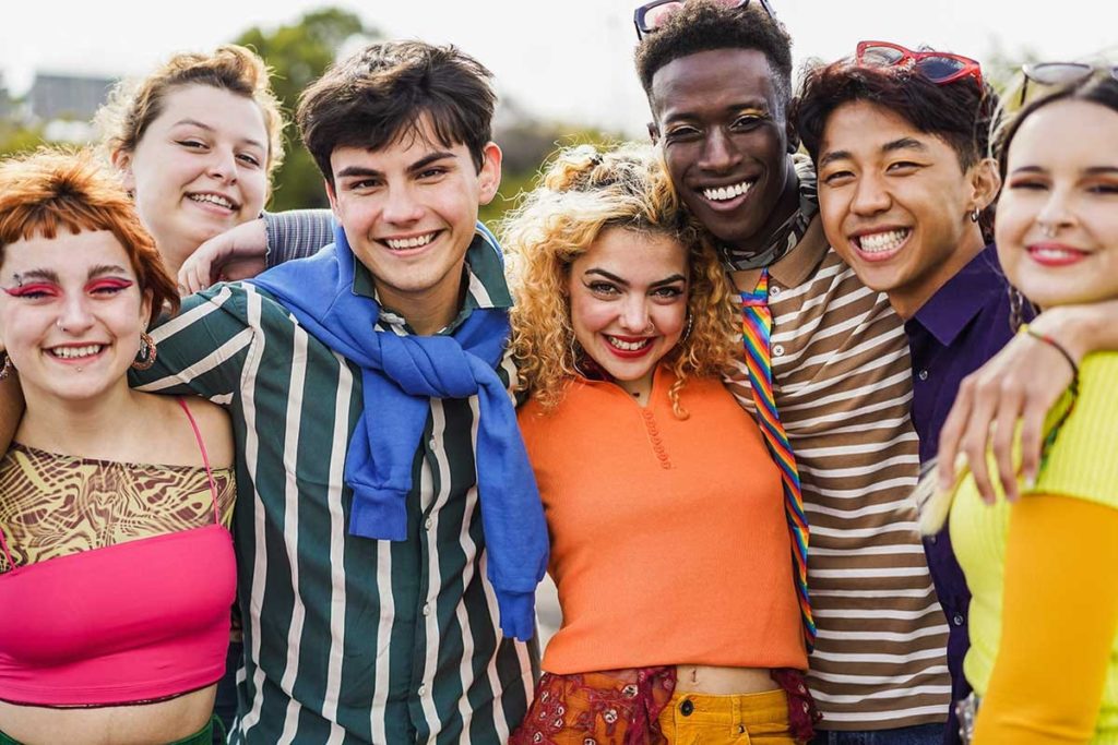 a group or people in an lgbtq alumni program smile at the camera