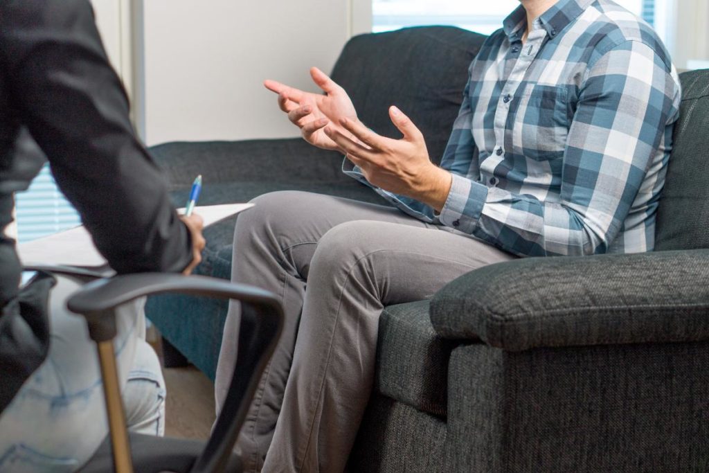 seated male therapist explaining how to prepare for intensive outpatient programs