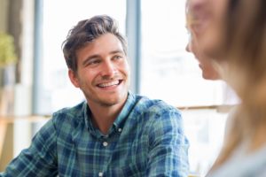 young man smiling as therapist explains what to expect in a residential treatment program