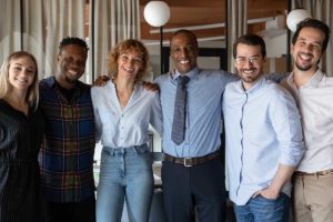 People in group therapy smiling and gathering together