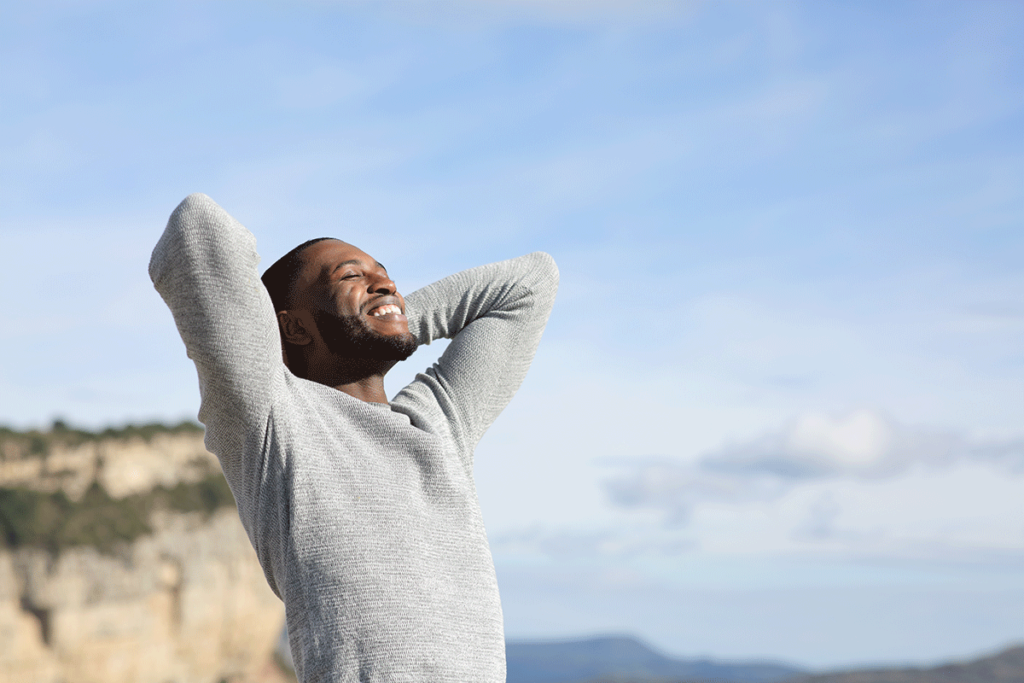 a man enjoys the benefits he has experienced since entering a sober living program in southern california on a nice beach