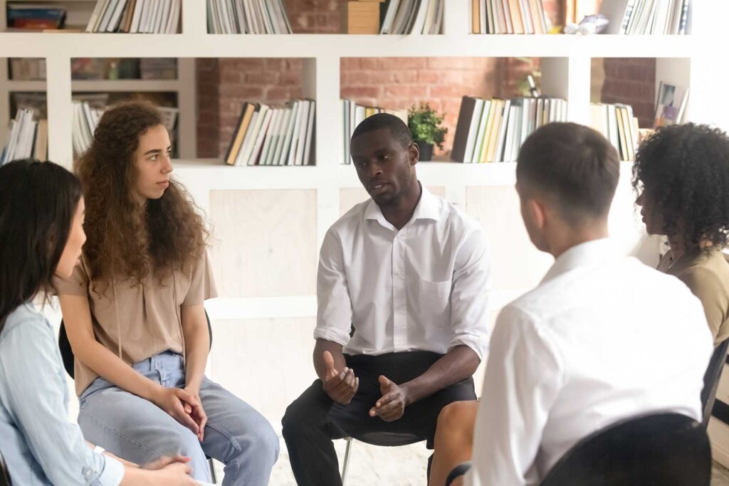 People sitting in a circle, basking in the benefits of GHB addiction rehab