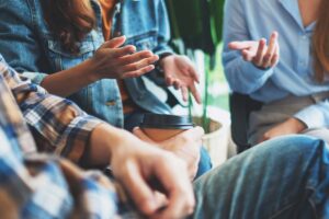 individuals participating in a group therapy session in an LGBTQ addiction treatment program