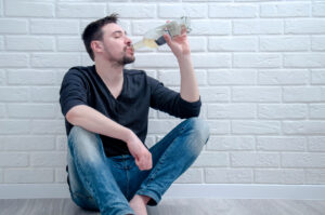White man drinking from bottle