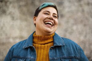 Non-binary person laughing