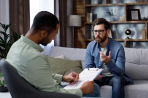 Seated man speaking to therapist