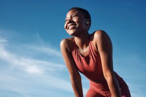 Young black woman resting hands on knees