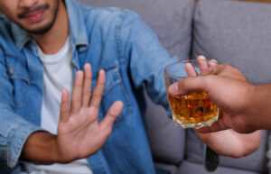 Young man refusing alcoholic drink