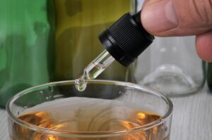 Concept Of Pouring GHB Into a Glass with a Pipette.